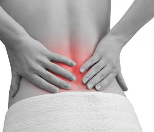 Woman holding her back as it is in either Acute or Chronic pain