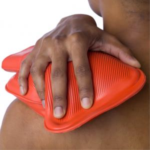 Image of a woman using a heat pack as pain relief