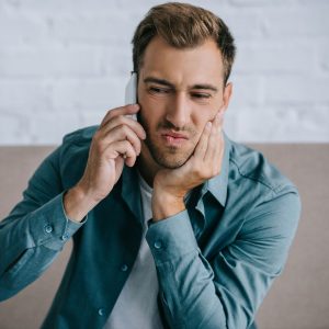 Image of a man in pain with TMJ dysfunction